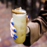 Holding a cinnamon cocktail from Refinery